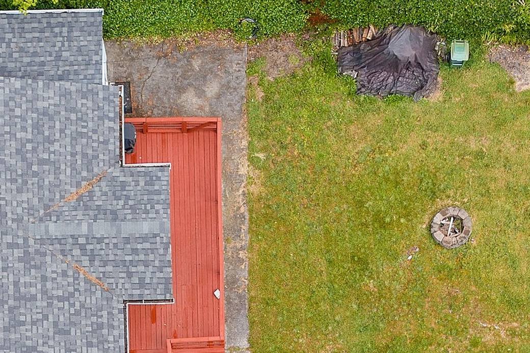The courtyard footprint before construction, bare lawn beside the house